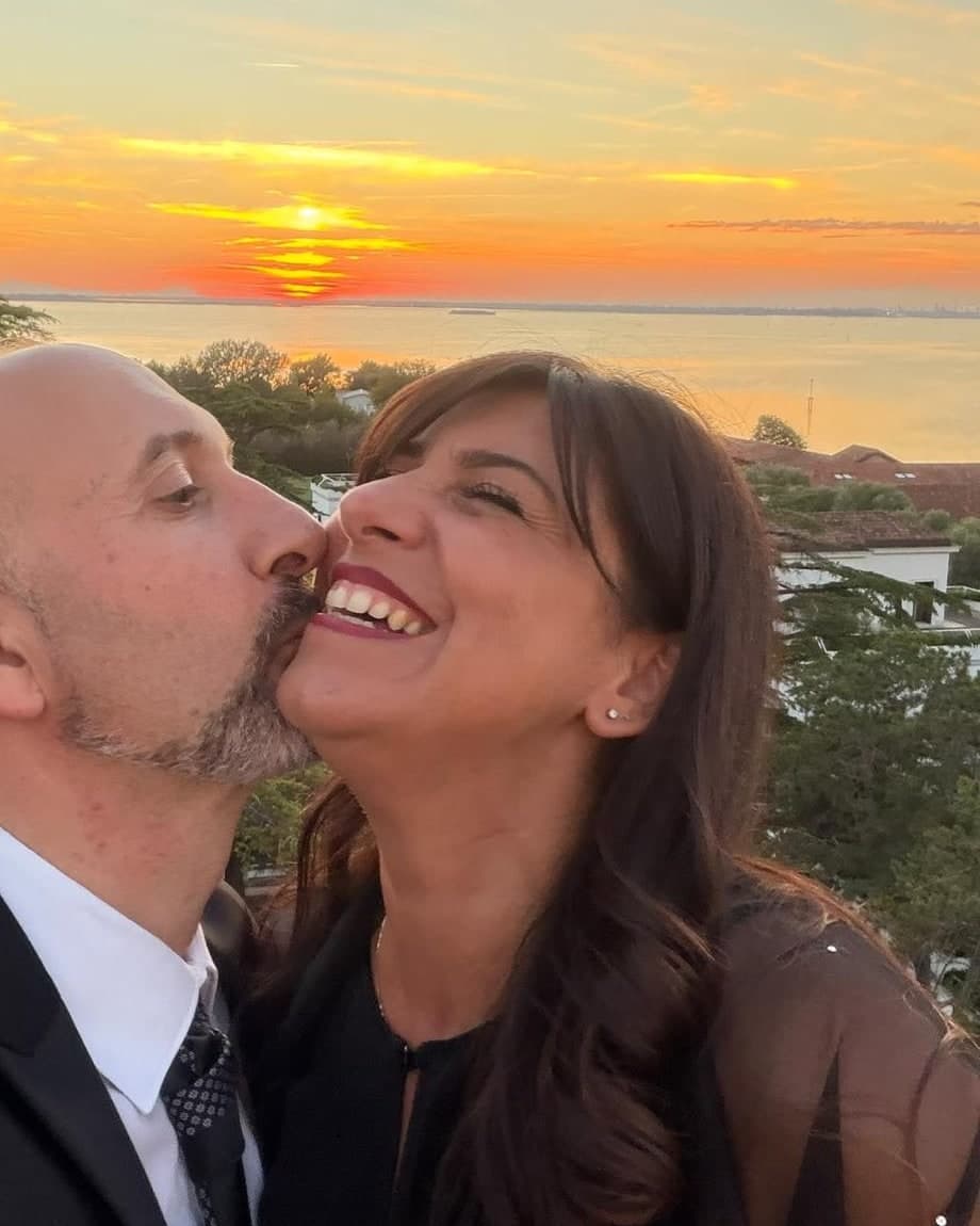 Sara Polato ride al tramonto mentre il marito la bacia sulla guancia